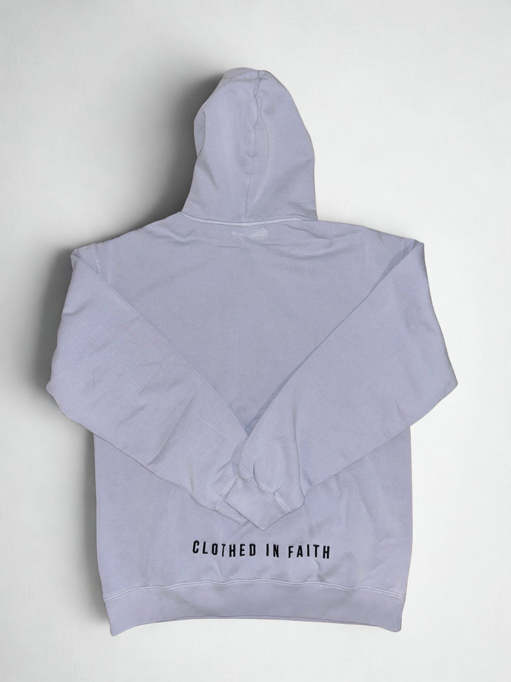 Folded light bluehoodie with text on a white background