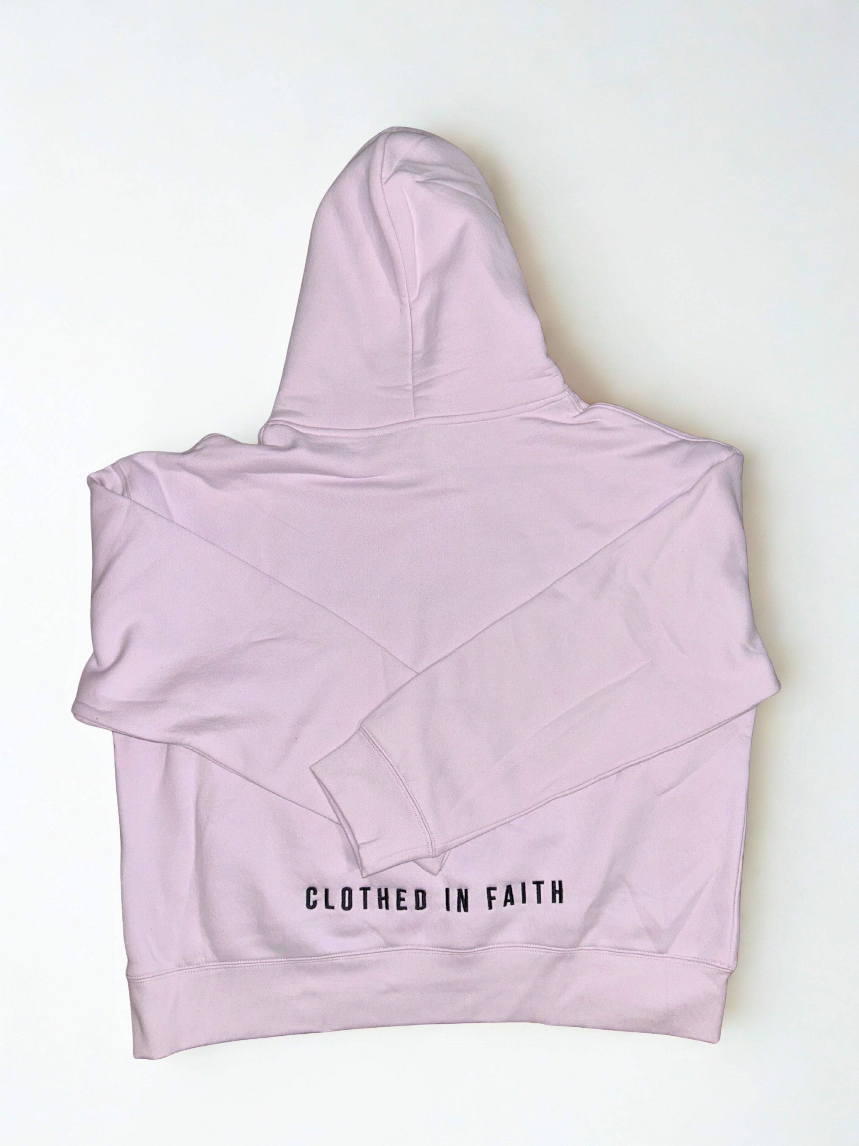 Light pink high-waisted bikini bottom with 'Clothed in Faith' text on a white background